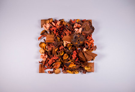 Flat lay layout of dry oranges, peach, nut, hazelnut and flowers. Top view. On trendy grey background. Minimal abstract season specific and autumn and winter concept.の写真素材