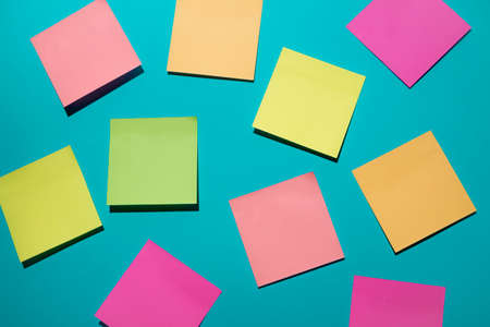Creative layout made of colorful sticker notes on blue background. Top view, flat lay. Minimal...