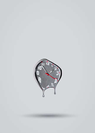 Melting clock on grey background. Time passing by idea. Minimal abstract life or business concept. With copy space.の写真素材