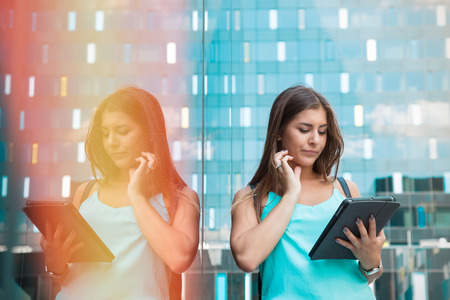 attractive young business assistant thinking of a solution while using a tabletの写真素材