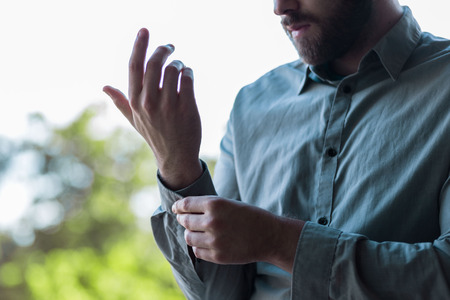 Handsome young businessman buttoning up his shirt and sleevesHandsome young businessman buttoning up his shirt and sleevesHandsome young businessman buttoning up his shirt and sleevesHandsome young businessman buttoning up his shirt and sleevesの写真素材