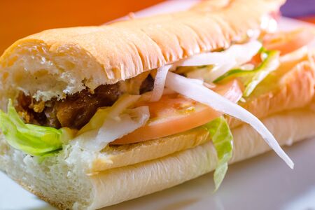 Delicious sandwiches with fresh tomatoes and roast beefの写真素材