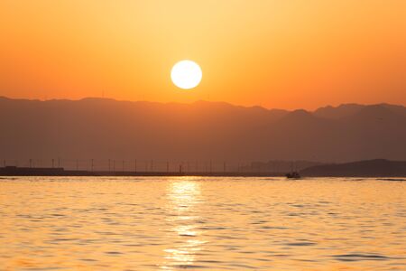 I saw the setting sun setting from the top of the shipの写真素材