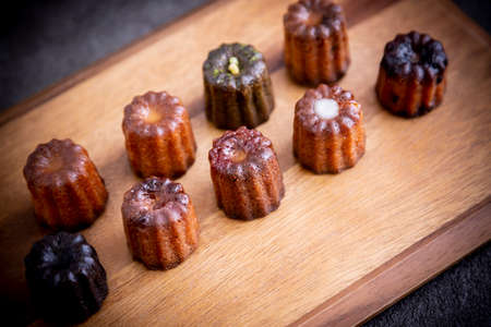 Served tea and canelÃ© on a cutting boardの写真素材