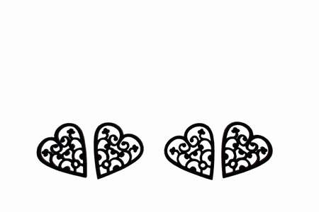 Carved wooden four hearts on a white background. Photo was taken against the light.の写真素材