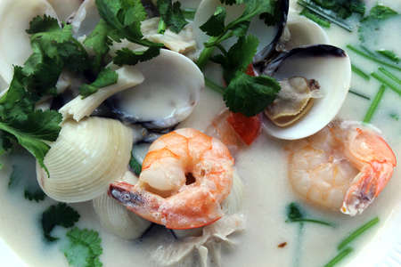 Traditional Thai spicy soup with shrimp, mushrooms, seafood and coconut milk.の写真素材