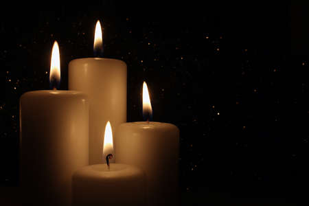 Candles Burning at Night on the dark background.の写真素材