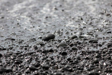 View through wet pebble on the sea.の写真素材