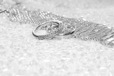 Engagement white gold ring and wedding band with diamonds on a pearl necklace.の写真素材