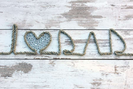 I love Dad. Composition on Father's Day. Rope text on the wooden table, closeup.の写真素材