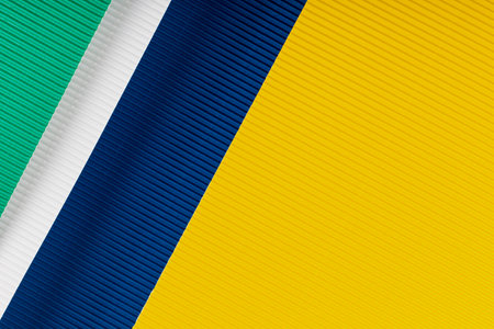 Blue, yellow, green and white corrugated paper texture. Geometric shapes and lines. Minimalist background. Flat lay. Copy space.の写真素材