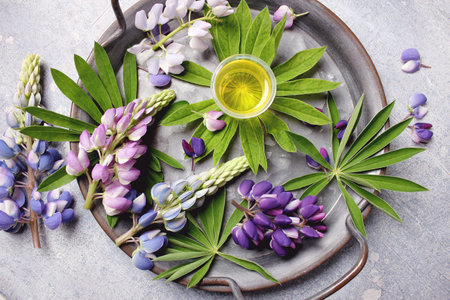 A top view of a serene spa setup with lupine flowers and a candle on a rustic surface.の写真素材
