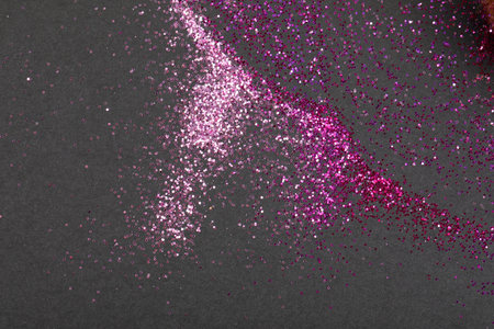 Colorful glitter crystals of eyelids makeup on black background. Beauty and fashion concept. Copy space. Flat lay.の写真素材