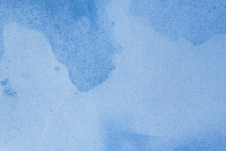 Wet stained paper background. Blue paper texture with water stains. Grunge background or texture.の写真素材