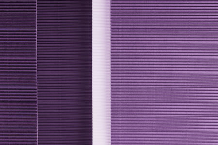 Purple corrugated paper texture. Geometric shapes and lines. Minimalist background. Flat lay. Copy space.の写真素材