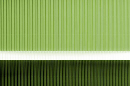 Light green and dark green corrugated paper texture. Geometric shapes and lines. Minimalist background. Flat lay. Copy space.の写真素材