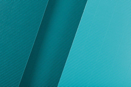 Blue corrugated paper texture. Geometric shapes and lines. Minimalist background. Flat lay. Copy space.の写真素材