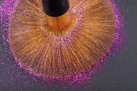 Colorful glitter crystals of eyelids makeup on black background. Beauty and fashion concept. Copy space. Flat lay.の写真素材