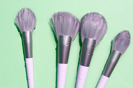 Makeup brush in clean water. Summer cosmetics concept. Top view.の写真素材