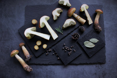 Mushrooms with spices on dark background. Flat lay, close up, copy space.の写真素材