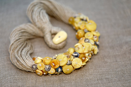 Amber necklace on linen napkin. Focus on the front. Close up.の写真素材