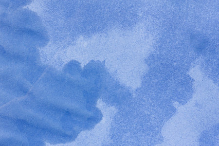 Wet stained paper background. Blue paper texture with water stains. Grunge background or texture.の写真素材
