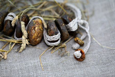 Natural unpolished amber necklace on a linen napkin. Focus ahead. Close up.の写真素材