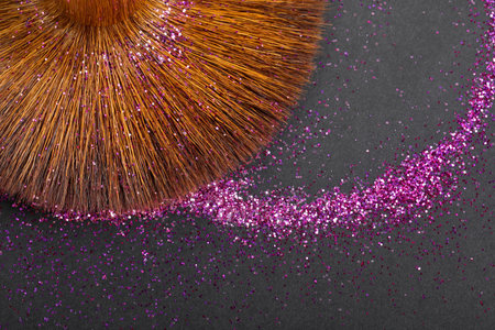 Colorful glitter crystals of eyelids makeup on black  background. Beauty and fashion concept. Copy space. Flat lay.の写真素材