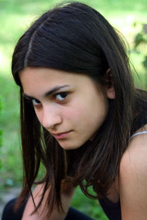 Teenage girl with mysterious smileの写真素材
