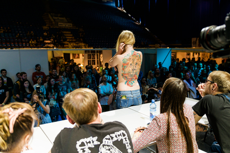 MINSK, BELARUS - SEPTEMBER 19, 2015: People show their tattoos for judging. The 2th International Tattoo Conventionのeditorial素材