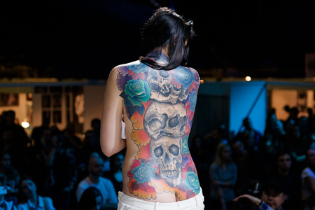 MINSK, BELARUS - SEPTEMBER 19, 2015: People show their tattoos for judging. The 2th International Tattoo Conventionのeditorial素材