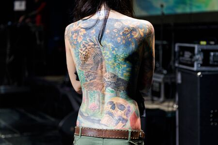 MINSK, BELARUS - SEPTEMBER 19, 2015: People show their tattoos for judging. The 2th International Tattoo Conventionのeditorial素材