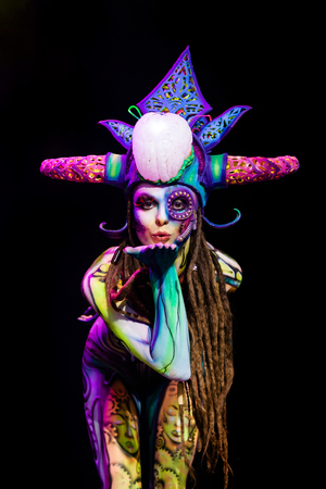 MINSK, BELARUS - SEPTEMBER 19, 2015: beautiful naked woman in a fantastic colorful body art and make-up. The 2th International Tattoo Conventionのeditorial素材