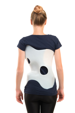 teenage patient in a corset Chenault isolated on white background. Treatment scoliosis.の写真素材