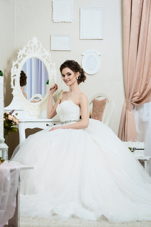 Beautiful young bride portrait with wedding makeup, hairstyle, dress.の写真素材