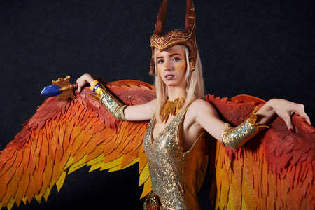 MINSK, BELARUS - NOVEMBER 03, 2018: UniÐ¡on Convention & Game Expo Minsk 2018. Cosplayer young woman dressed as Phoenix from Dota 2 shoot on black background in photo zoneのeditorial素材
