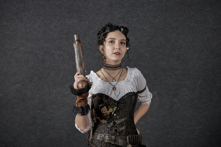 MINSK, BELARUS - NOVEMBER 03, 2018: UniÐ¡on Convention & Game Expo Minsk 2018. Cosplayer young woman dressed steampunk style shoot on black background in photo zoneのeditorial素材