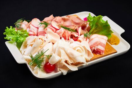 meat and sowbelly set. pub, restaurant, bar food concept. meat appetizers set with meat, sowbelly, tomatoes cherry, souses and fresh greens.の写真素材