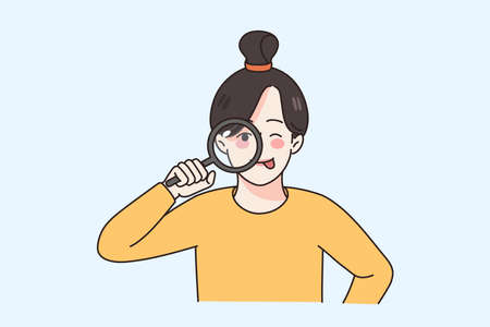 Curious girl look through magnifying glass
