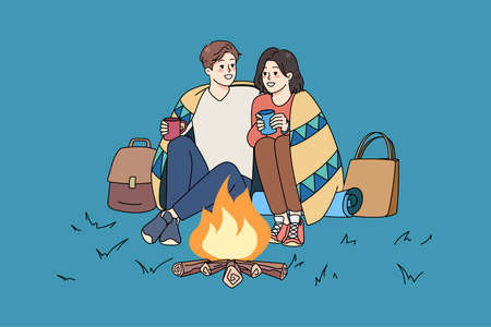 Happy couple sit near fire on romantic dateのイラスト素材