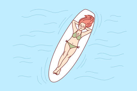 Happy woman lying on board in seaのイラスト素材