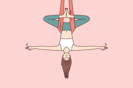 Woman doing aerial yoga hangs upside down in hammock and keeps balance with arms at sidesのイラスト素材