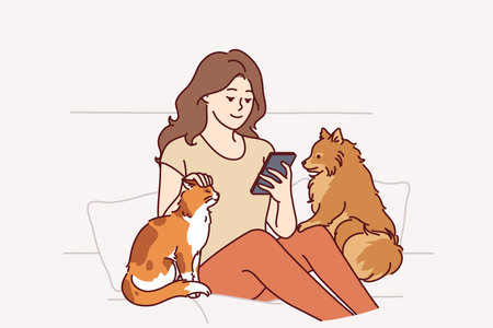 Woman owner of dog and cat sits on couch and plays on phone, enjoying spending time with petsのイラスト素材