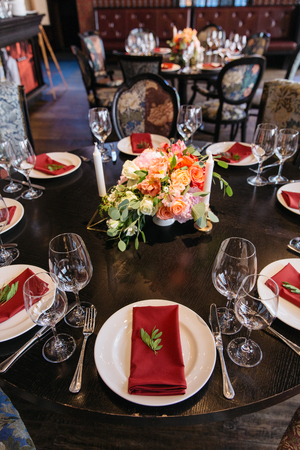 Candle and flower decoration for an event party or wedding in a restaurant. Elegance table set up.の写真素材