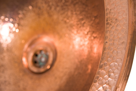 Detail of copper round sink. Brown copper sink in retro style. Antique sink for home. Macro shooting.の写真素材