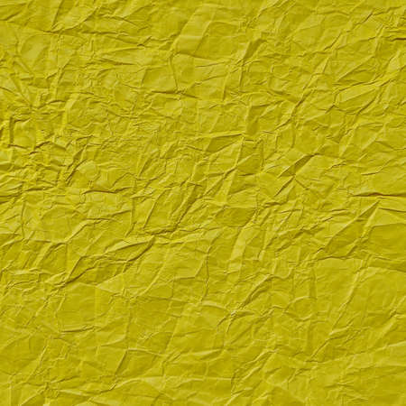 Realistic crumpled yellow paper texture backgroundの写真素材