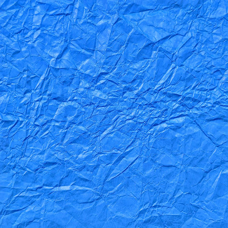 Realistic crumpled sky blue paper texture backgroundの写真素材