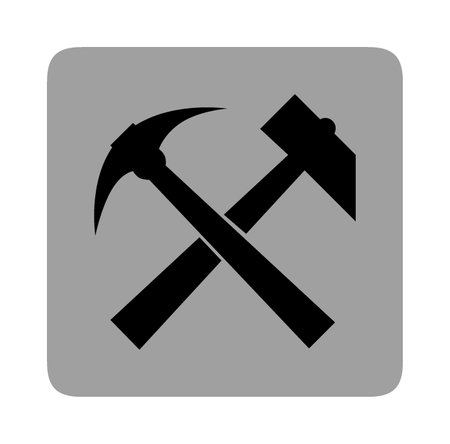 A flat black mining icon on a grey background consisting of a pick and a hammer.の写真素材