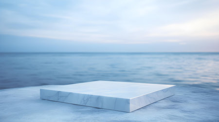 Square Marble Podium in blue Colors in front of a blurred Seascape. Luxury backdrop for product presentationの素材