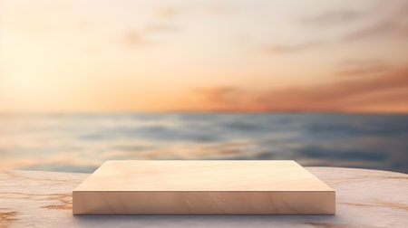 Square Marble Podium in beige Colors in front of a blurred Seascape. Luxury backdrop for product presentationの素材